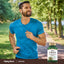 A man running outdoors holding a Chrysin supplement bottle, embodying an active lifestyle.