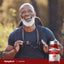 Older man smiling while hiking outdoors with a Lycopene bottle next to him.