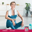 A woman in workout gear sits on a yoga mat with a towel around her neck next to MSM Powder.