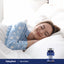 A woman sleeping in bed next to a bottle of Fast Dissolve Melatonin 5 mg.