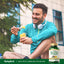 Young man eating fruit outdoors next to a bottle labeled Milk Thistle, Dandelion & Yellow Dock Complex.