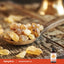 Frankincense resin pieces in a wooden spoon with a Piping Rock Frankincense Oil bottle in the corner