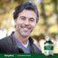 Smiling middle-aged man outdoors with a Potassium Citrate bottle beside him.