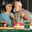 Senior man and woman laughing while cooking in a kitchen, with a bottle of Ultra Vanadyl Sulfate visible.