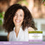A middle-aged woman smiling at the camera next to a jar of Vitamin K Cream.