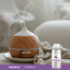 Lavender Oil 16 FL OZ (473 mL) pure essential oil bottle beside a wooden diffuser releasing mist.